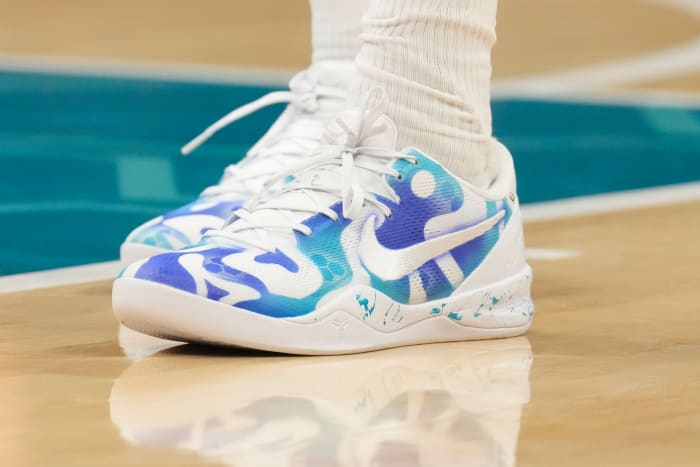 Charlotte Hornets forward Brandon Miller's white and teal Nike shoes.